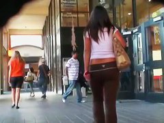 A black haired chick gets followed by a spy on the street
