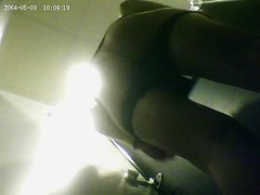 A fit milf is getting dresed in a sport club changing room