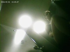 A fit milf is getting dresed in a sport club changing room