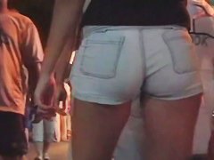 A hot brunette lady n the shortest pants ever smoking a cig