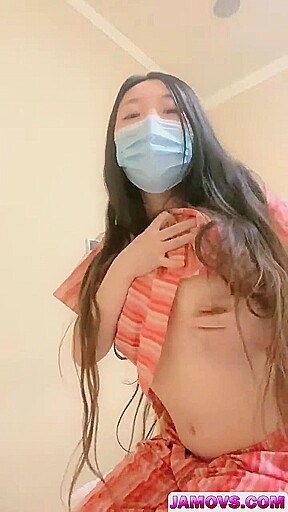 An Asian woman is seen urinating on in a public washroom