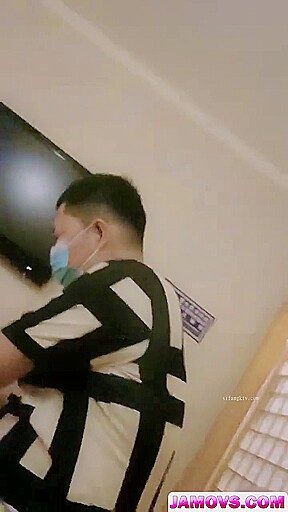 An Asian woman is seen urinating on in a public washroom