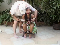 Attractive Asian babe restrained on a chair