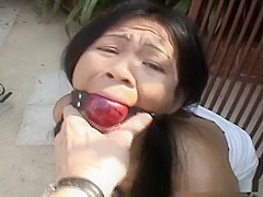 Attractive Asian babe restrained on a chair