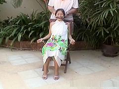 Attractive Asian babe restrained on a chair
