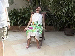 Attractive Asian babe restrained on a chair