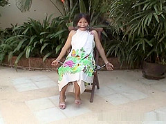 Attractive Asian babe restrained on a chair