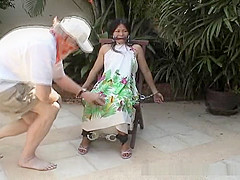 Attractive Asian babe restrained on a chair