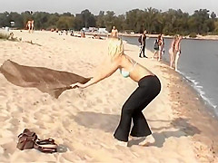 Blonde nudist girl at a beach