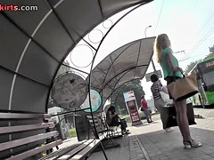 Blonde waits for a bus in the upskirt outdoor scene