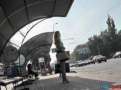 Blonde waits for a bus in the upskirt outdoor scene