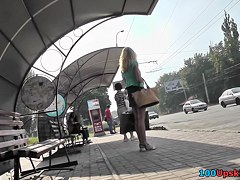 Blonde waits for a bus in the upskirt outdoor scene