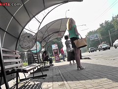 Blonde waits for a bus in the upskirt outdoor scene