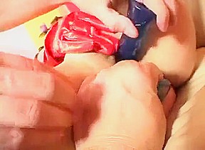 Brunette in red PVC gloves and boots gives blowjob