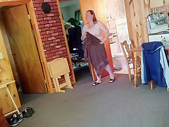 Chubby wife combing her hair in bathroom