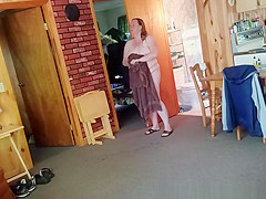 Chubby wife combing her hair in bathroom