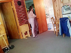 Chubby wife combing her hair in bathroom