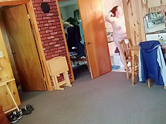 Chubby wife combing her hair in bathroom