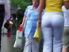 Classy blonde in heels and white pants in a street candid vid