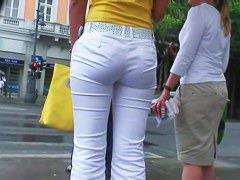 Classy blonde in heels and white pants in a street candid vid