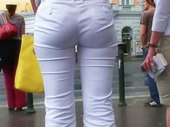Classy blonde in heels and white pants in a street candid vid