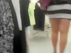 Curvy woman in a short skirt goes shopping