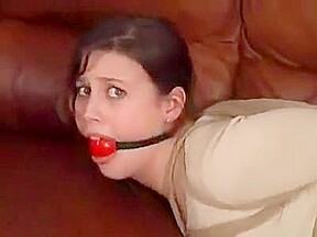 Dolly hogtied and ballgagged on sofa