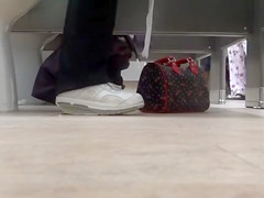 Female feet and shoes in the public toilet