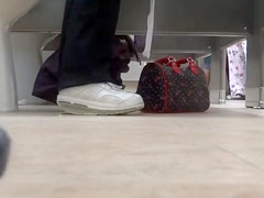 Female feet and shoes in the public toilet
