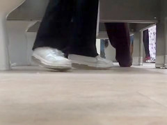 Female feet and shoes in the public toilet