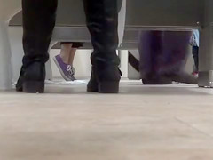 Female feet and shoes in the public toilet