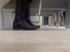 Female feet and shoes in the public toilet