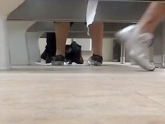 Female feet and shoes in the public toilet