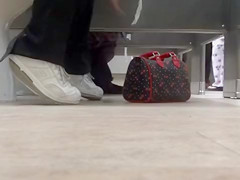 Female feet and shoes in the public toilet