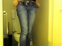 Girl in glasses pees in bathroom toilet