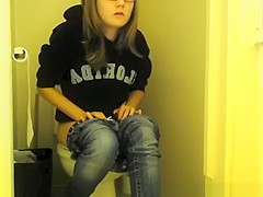 Girl in glasses pees in bathroom toilet