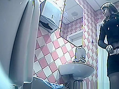 Girl in shorts pees in toilet