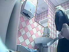 Girl in shorts pees in toilet