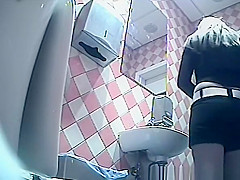 Girl in shorts pees in toilet