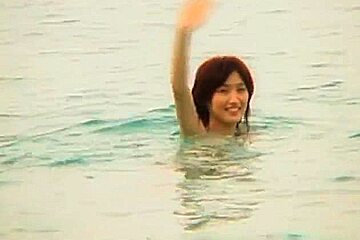 Hot and sexy brunette Asian babe gagging hard cocks and double penetrated on the beach