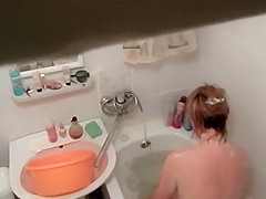 Hot woman washes in the bathtub