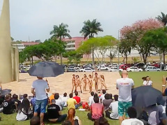 Naked singing and dancing girls put on a public show