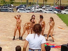 Naked singing and dancing girls put on a public show
