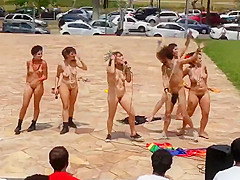 Naked singing and dancing girls put on a public show