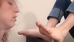 Slave claire licking mistress Amelia's feet