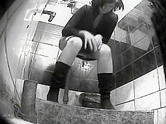 Spying a girl pissing at a public toilet