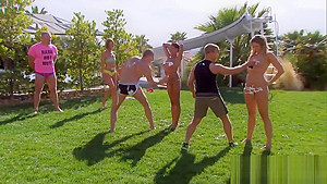 Swinging couples playing with water guns