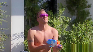 Swinging couples playing with water guns