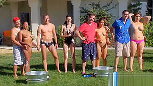 Swinging couples playing with water guns