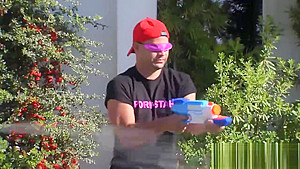 Swinging couples playing with water guns